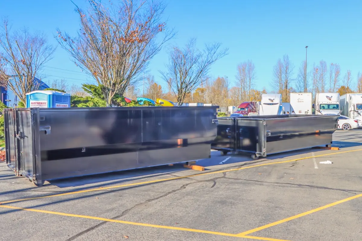 Professional dumpster rental service with roll-off container on residential driveway in Niles